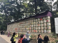 a group of people standing in front of a shrine