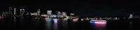 a city at night with illuminated boats in the water