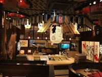 the interior of a japanese restaurant with a lot of decorations