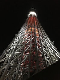 the tokyo tower lit up at night