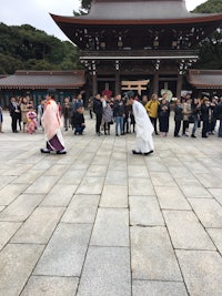 a group of people standing on a stone walkway