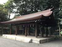 a wooden pavilion in the middle of a wooded area