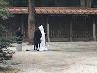 a group of people standing in a wooded area